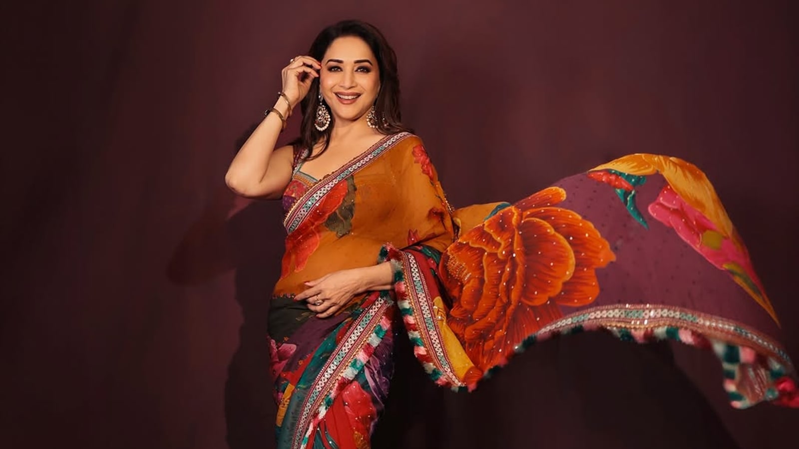 ‘Instead of all the pakodas and samosa on the set, I’d rather eat this’: From a passport-size photo of husband Dr Shriram Nene to a toilet seat sanitiser, these are the essentials Madhuri Dixit carries in her bag | Fashion News