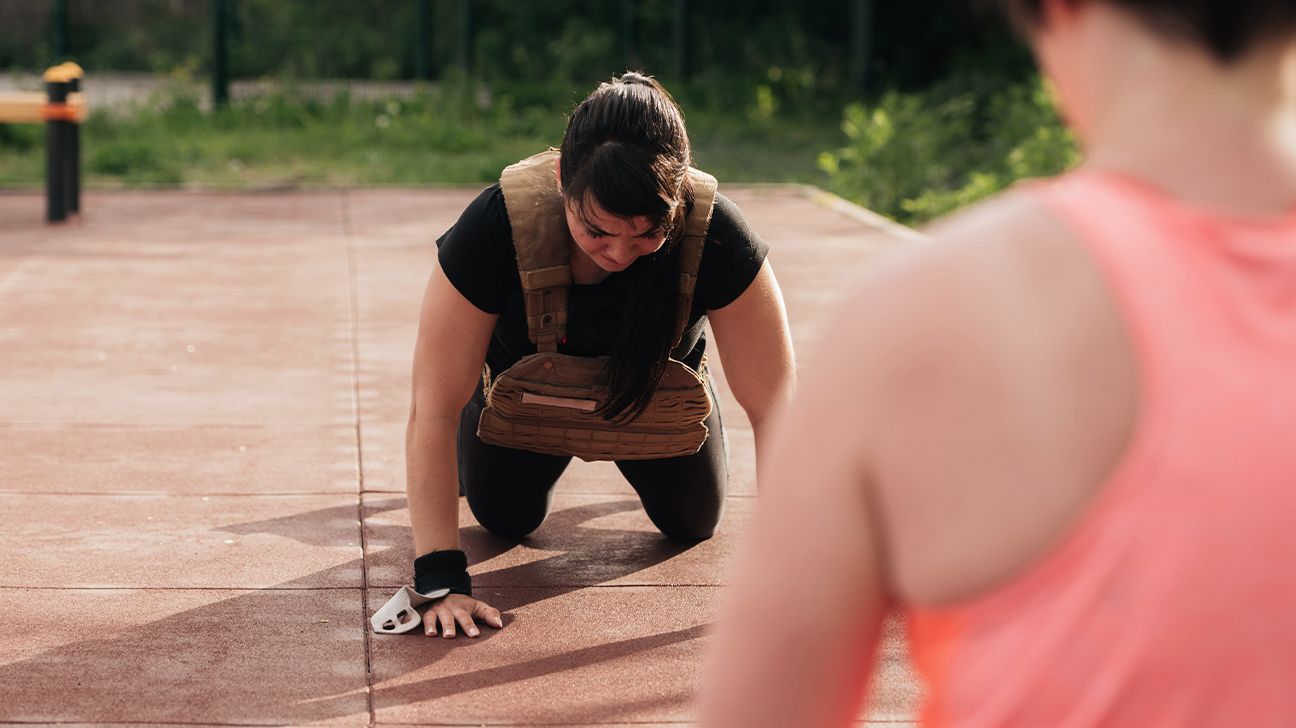 Female wearing weighted vest during CrossFit workout